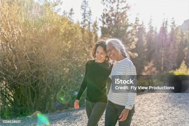 Portrait Of Beautiful Mixed Race Senior Woman Spending Time With Her Adult Daughter Outdoors Stock Photo - Download Image Now