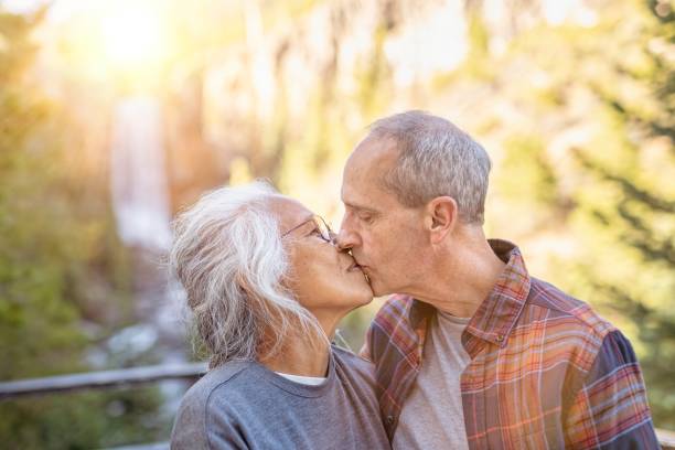 istock Relaxed senior couple on vacation taking a selfie by waterfall 1326528505