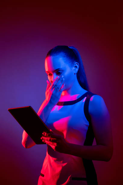 istock cyber attack digital scam scared neon woman tablet 1326528543