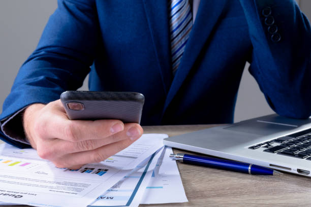 istock Midsection of caucasian businessman using smartphone, isolated on grey background 1326528641