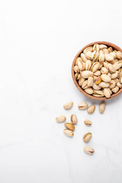 istock pistachios nuts in wooden bowl 1326528761