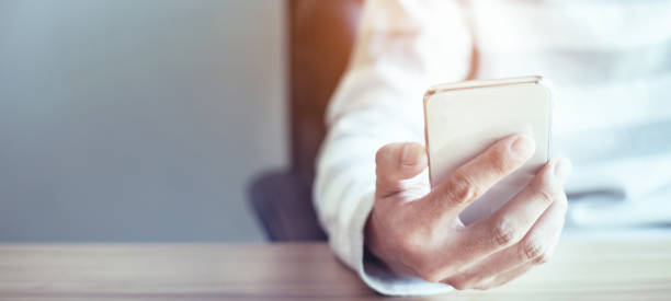 istock hand man holding mobile phone, customer support concept 1326534493