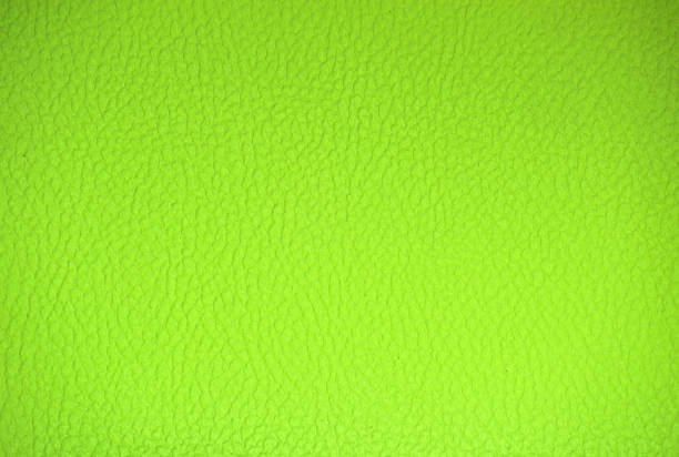 Fragment of genuine leather, quality workmanship, painted in acid green color. Background, pattern, texture.