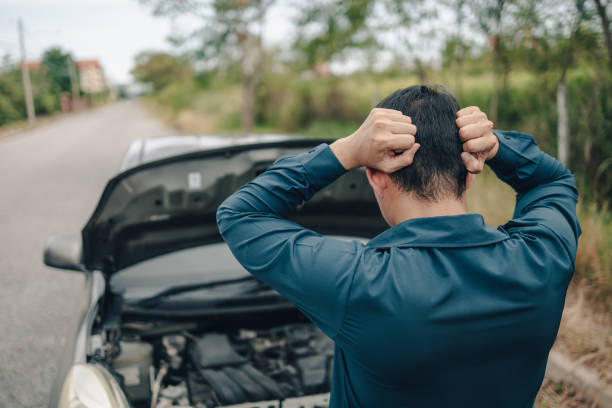 grave mal di testa dell'uomo davanti al guasto dell'auto e cofano aperto sul ciglio della strada. concetto rotto dell'auto. - roadside emergency foto e immagini stock