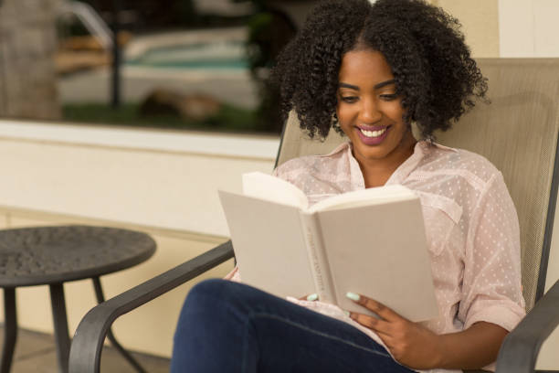 istock African American woman reading a book. 1326546323