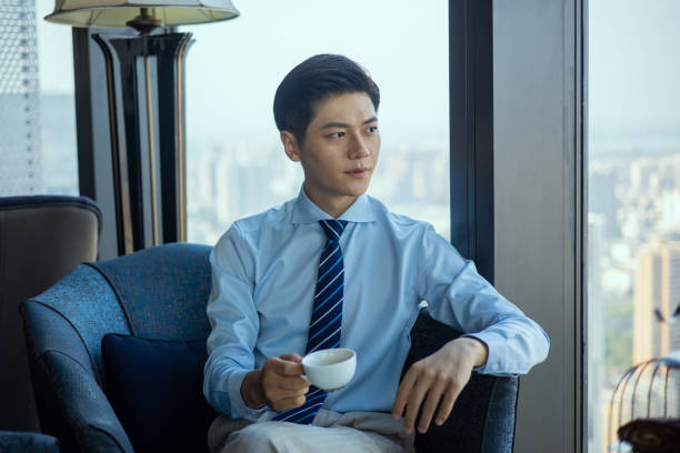 istock Businessman sitting and drinking cup of coffee 1326547245