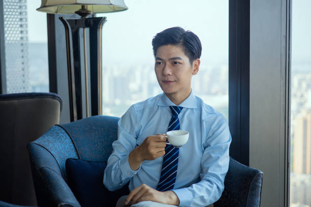 istock Businessman sitting and drinking cup of coffee 1326547279