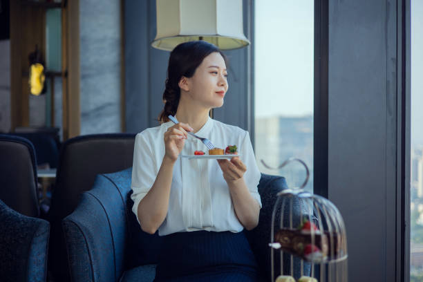 istock Young women eating cake in cafe 1326547312