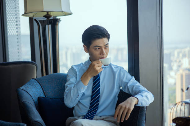 istock Businessman sitting and drinking cup of coffee 1326547372