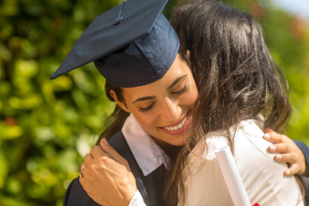 istock Mother hugging her daughter at her graduation 1326548127