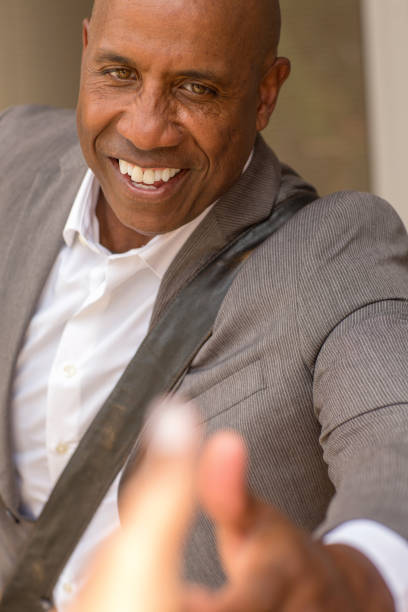 istock Handsome African American man shaking hands and drinking coffee. 1326548445