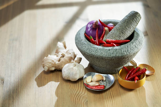 food ingredient  on wood background  including peppers, ground chili, garlic and onion