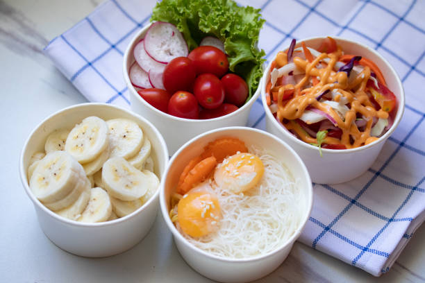 istock Take away healthy food in foil boxes on marble table. 1326551980