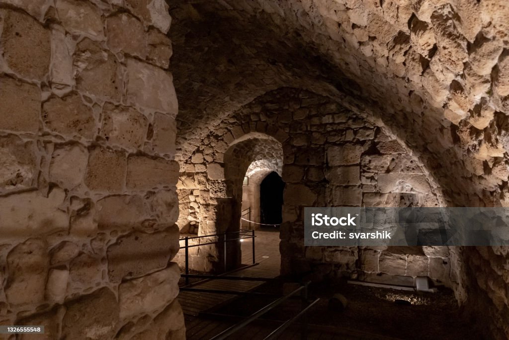 Passage  between stone halls of the Crusader fortress of the old city of Acre in northern Israel Passage between stone halls of the Crusader fortress of the old city of Acre in northern Israel Acco Stock Photo