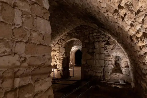 Passage between stone halls of the Crusader fortress of the old city of Acre in northern Israel