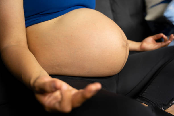 istock Pregnant woman sitting in a meditation pose. 1326555612