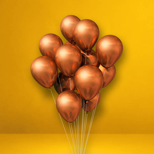 istock Copper balloons bunch on a yellow wall background 1326556299