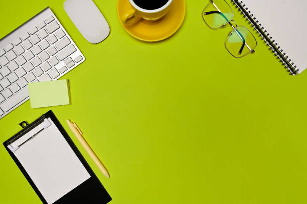 istock Top view empty clipboard, glasses, coffee cup and sticky note on green background. 1326557142