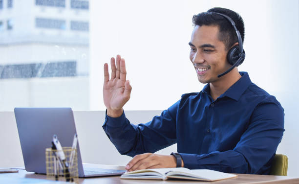 istock Shot of a young businessman wearing a headset while using a laptop in an office 1326558003