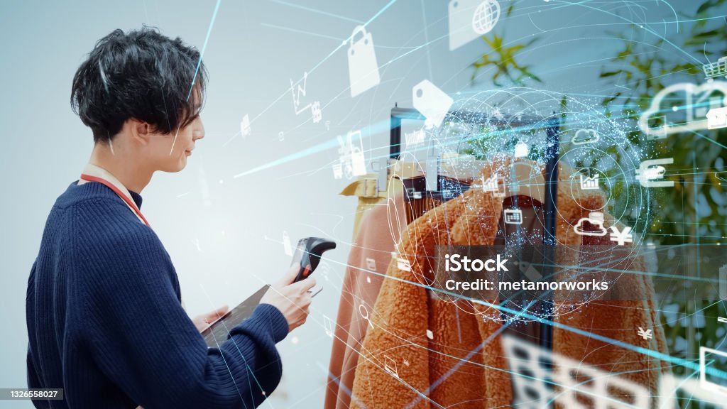 Store clerk scanning products with a smart phone. Retail as a Service. RaaS. Retail Stock Photo