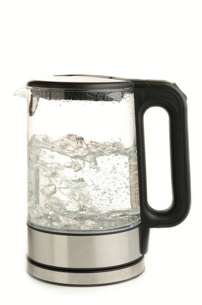 istock Glass electric kettle with boiling water, isolated on white background. 1326558107