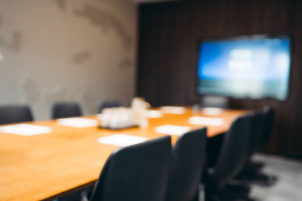 defocused blurred modern empty meeting room with big conference table. - board meeting bildbanksfoton och bilder