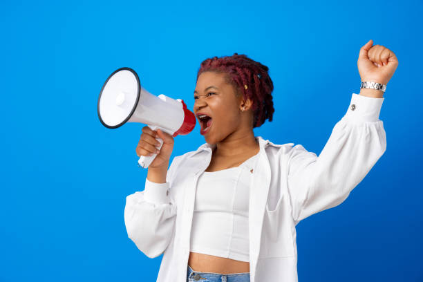 istock African american woman using megaphone against blue background 1326558965