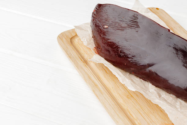 istock Raw beef liver on wooden board on table 1326559881