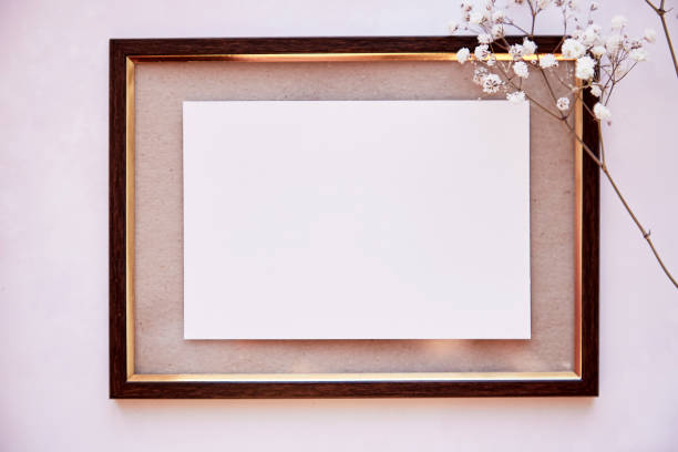 istock Elegant brown frame mockup on vintage surface. Vintage frame with gipsophila. Beige background, Scandinavian interior. Place for advertising, thank you or wishing 1326560699