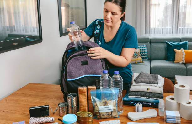 istock Woman putting a water bottle to prepare emergency backpack 1326563696