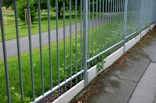 istock fence with a lower part which is made of concrete slabs as protection against game. undercutting the fence may occur. now the house and garden are protected. 1326564120