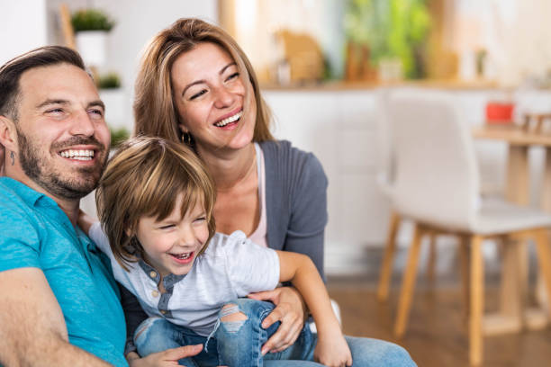 istock Happy parents and their small boy having fun at home. 1326565861
