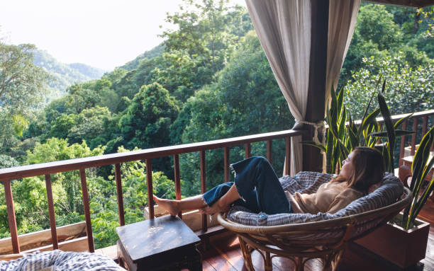 istock A young woman lying and relaxing on sofa while looking at a beautiful nature view 1326566105