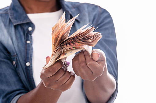 Close up of money bills held by african woman's hands: Money concept