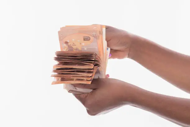 Photo of A bunch of money bills held by black female hands