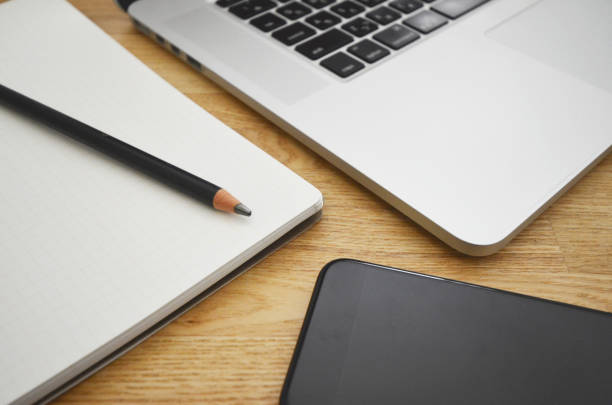 istock Laptop, smartphone, notebook, pencil on natural wooden table 1326568246