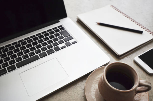 istock Concrete table with a laptop, smartphone, notebook, pencil and a cup of coffee 1326568264