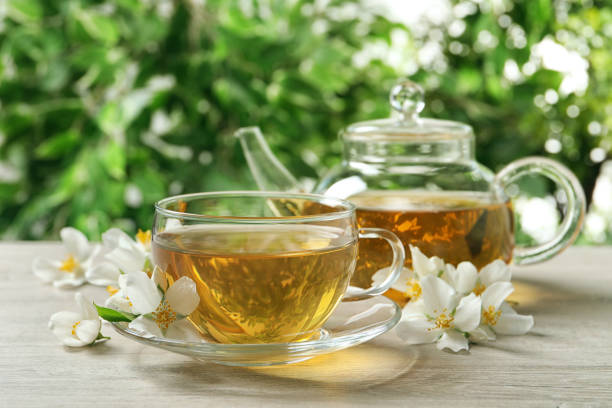 istock Aromatic jasmine tea and fresh flowers on wooden table 1326570366