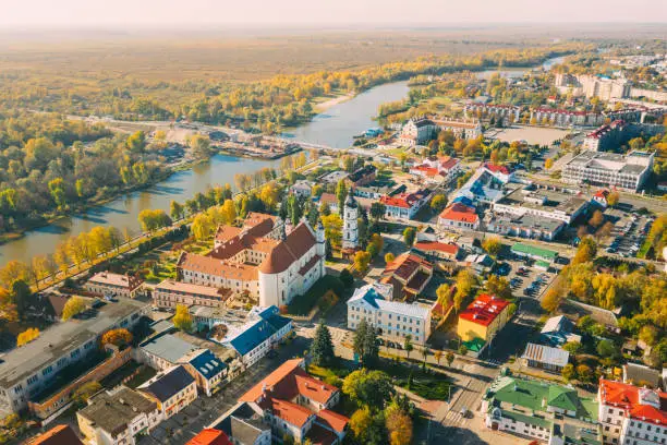 Photo of Pinsk, Brest Region, Belarus. Pinsk Cityscape Skyline In Autumn Morning. Bird's-eye View Of Cathedral Of Name Of The Blessed Virgin Mary And Monastery Of The Greyfriars. Famous Historic Landmarks