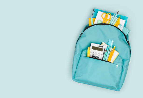 istock School backpack with different colorful stationery products on blue background 1326575362