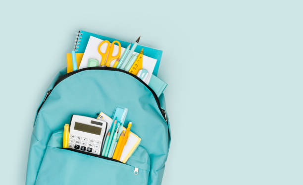 close-up of school backpack with colorful stationery and text space - mochila imagens e fotografias de stock