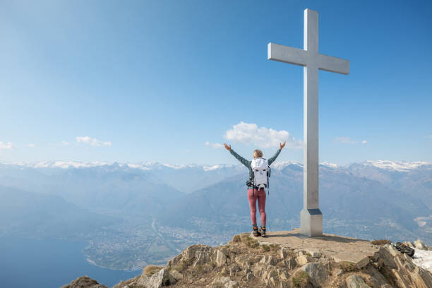 istock Hiker stands arms out on mountain top 1326575748