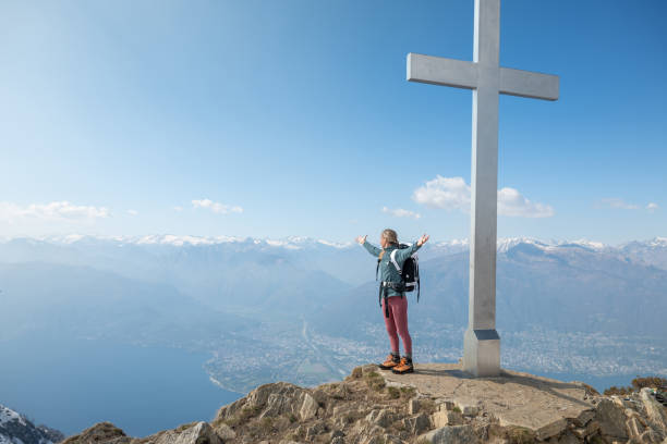 istock Hiker stands arms out on mountain top 1326575750