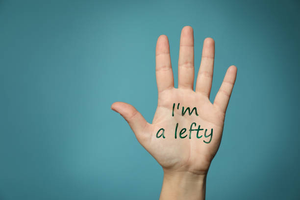 Left-handed woman holding open palm on light blue background, closeup Left-handed woman holding open palm on light blue background, closeup left handed stock pictures, royalty-free photos & images