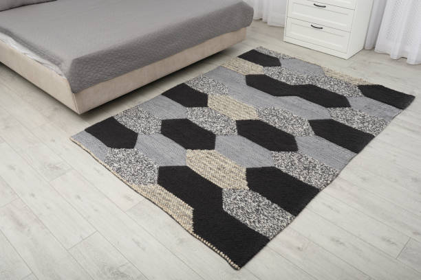 istock Stylish carpet with pattern on floor in bedroom 1326576900
