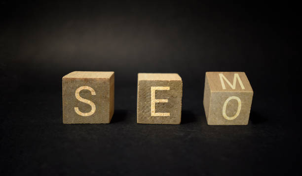 istock SEO versus SEM. Turning a cube and changing SEO into SEM. Concept for Search Engine Optimization and Search Engine marketing against black background. 1326578774