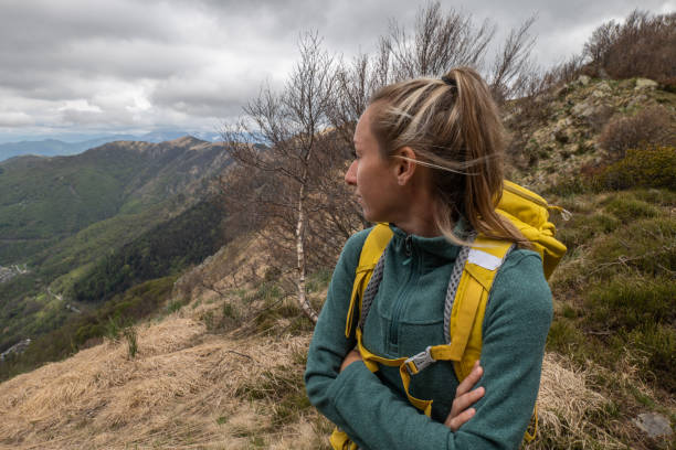 istock Female hiker contemplates view from mountain top 1326579133