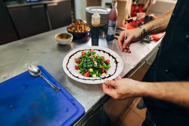 istock Creative chef, decorating the salad bowl with a sauce making an interesting shape 1326579537
