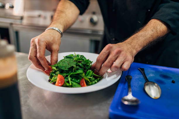 istock Professional chef, arranging the fresh salad in his kitchen 1326579538
