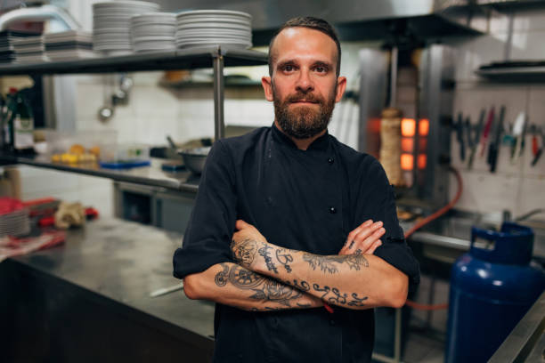 istock Modern and confident male chef, in his uniform proudly standing in his modern kitchen 1326580273